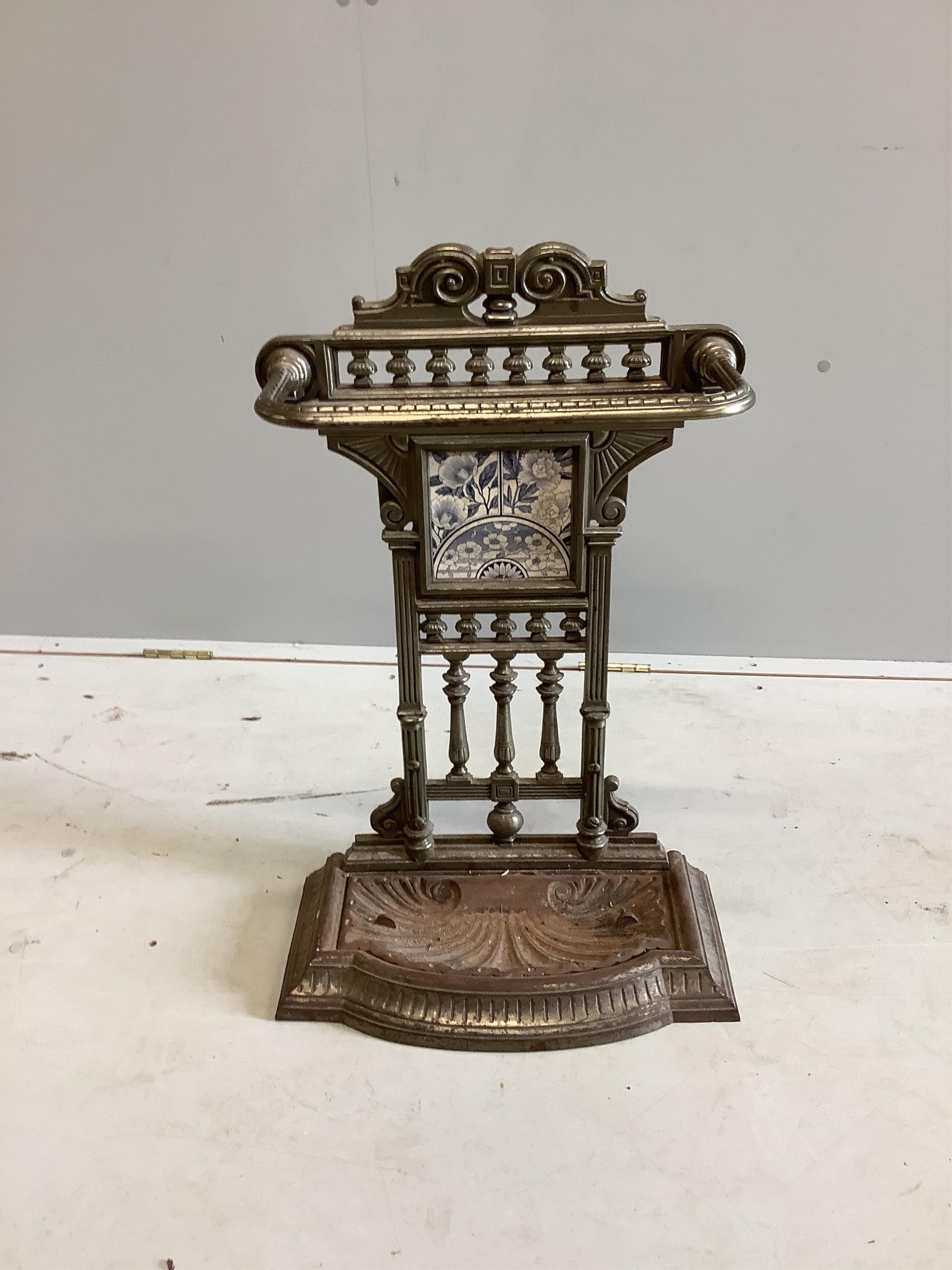 A Victorian steel stick stand with tile inset back, width 44cm, height 71cm. Condition - fair